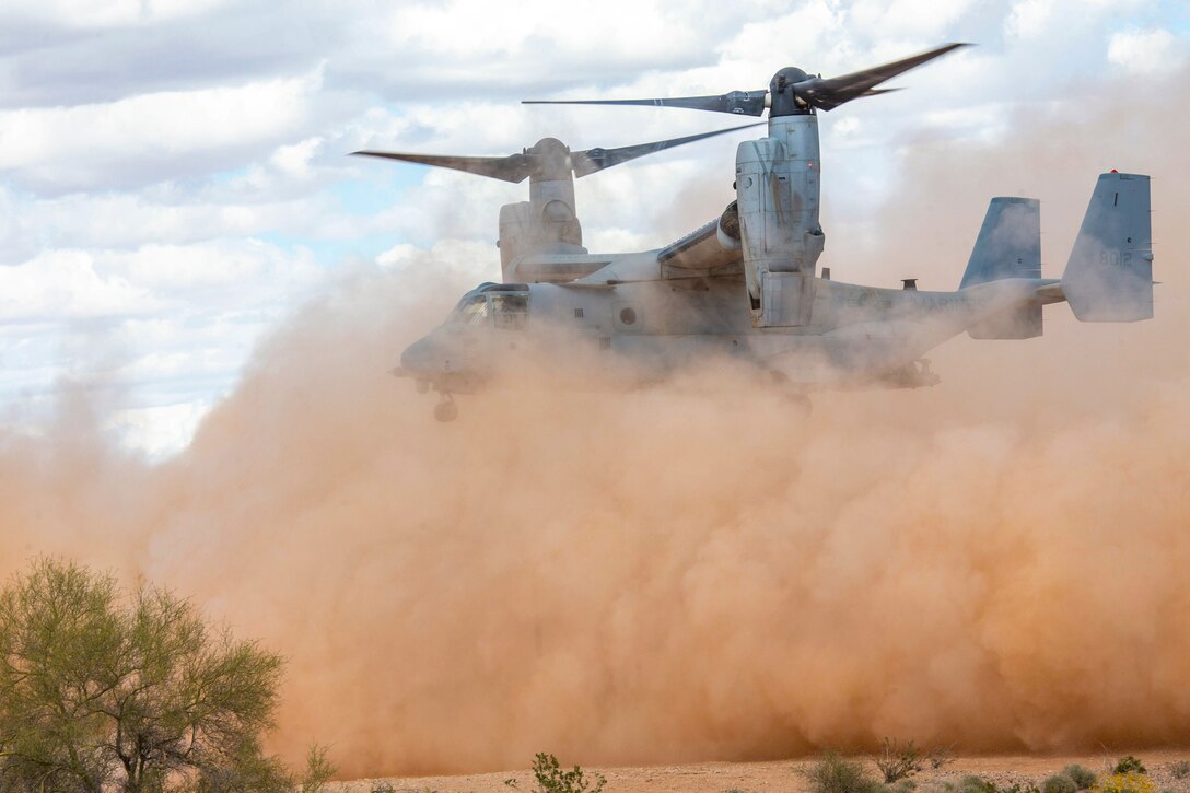 Large clouds of dust fill the air as an aircraft prepares to land.