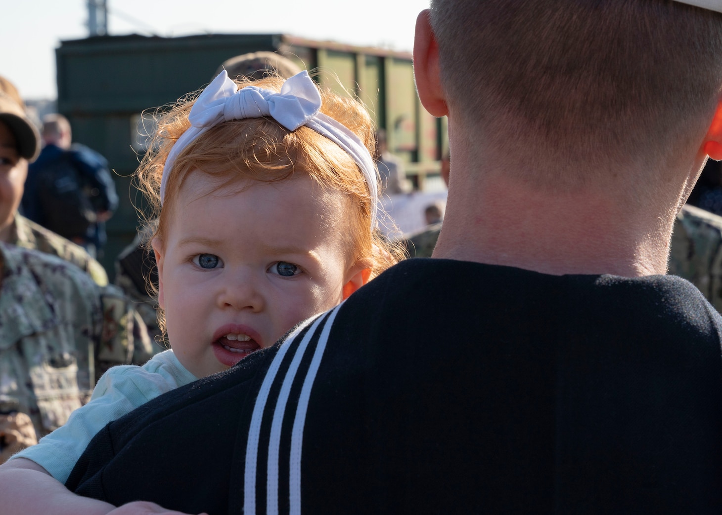 Fire Controlman (Aegis) 2nd Class Robert Heinke, assigned to the guided-missile cruiser USS Vicksburg (CG 69) and deployed with guided-missile destroyer USS Nitze (DDG 94), embraces his daughter while he is greeted by friends and family after Nitze returned to Naval Station Norfolk following a scheduled deployment April 5, 2023.