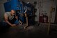 U.S. Air Force Staff Sgt. Bryce Harris inspects a metal project