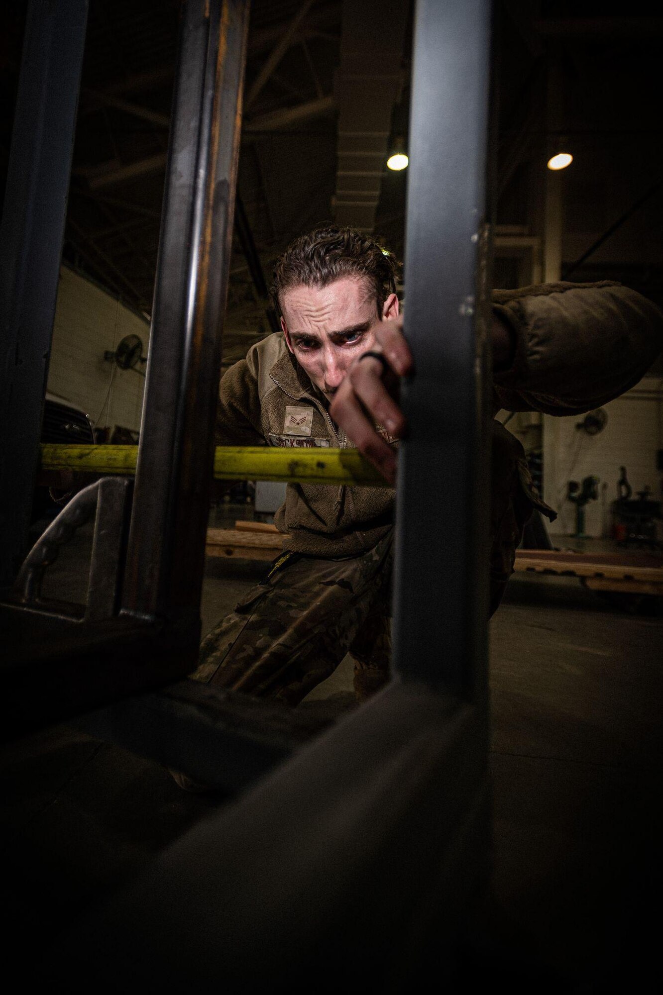 U.S. Air Force Senior Airman Garrett Jackson uses a measuring tape