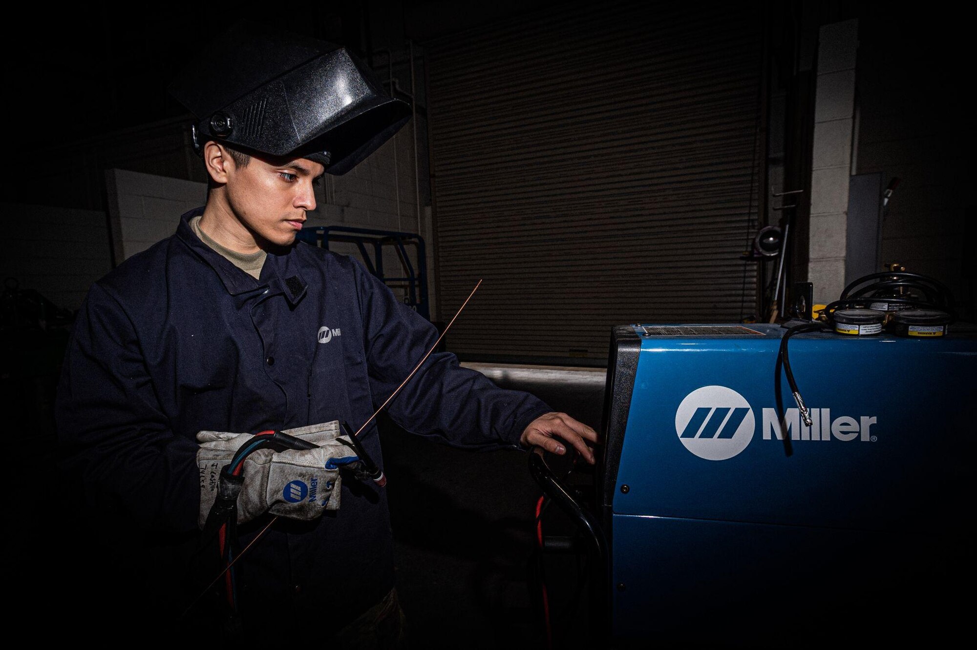 U.S. Air Force Senior Airman Jalen Castillo prepares a welding machine