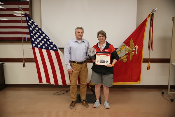 Patricia Kay Rowland, right, is presented with Production Plant Albany’s (PPA)  Direct Civilian-Marine of the Quarter Award for the first quarter of FY23, by Harry H. Bailey Jr., left, plant manager, PPA, Marine Depot Maintenance Command (MDMC), during an awards ceremony held at Marine Corps Logistics Base Albany, Ga., March 23.  Rowland is an Information Technology Specialist assigned to PPA’s Test, Measurement and Diagnostic Equipment Division, MDMC.