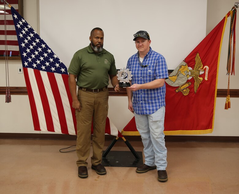 Corey L. Lacey, right, is presented with Production Plant Albany’s (PPA)  In-direct Civilian-Marine of the Quarter Award for the first quarter of FY23, by Vincent M. Hutcherson, left, deputy commander, Marine Depot Maintenance Command (MDMC), during an awards ceremony held at Marine Corps Logistics Base Albany, Ga., March 23.  Lacey is a Production Shop Planner currently assigned to PPA’s Business and Digital Integration Division.