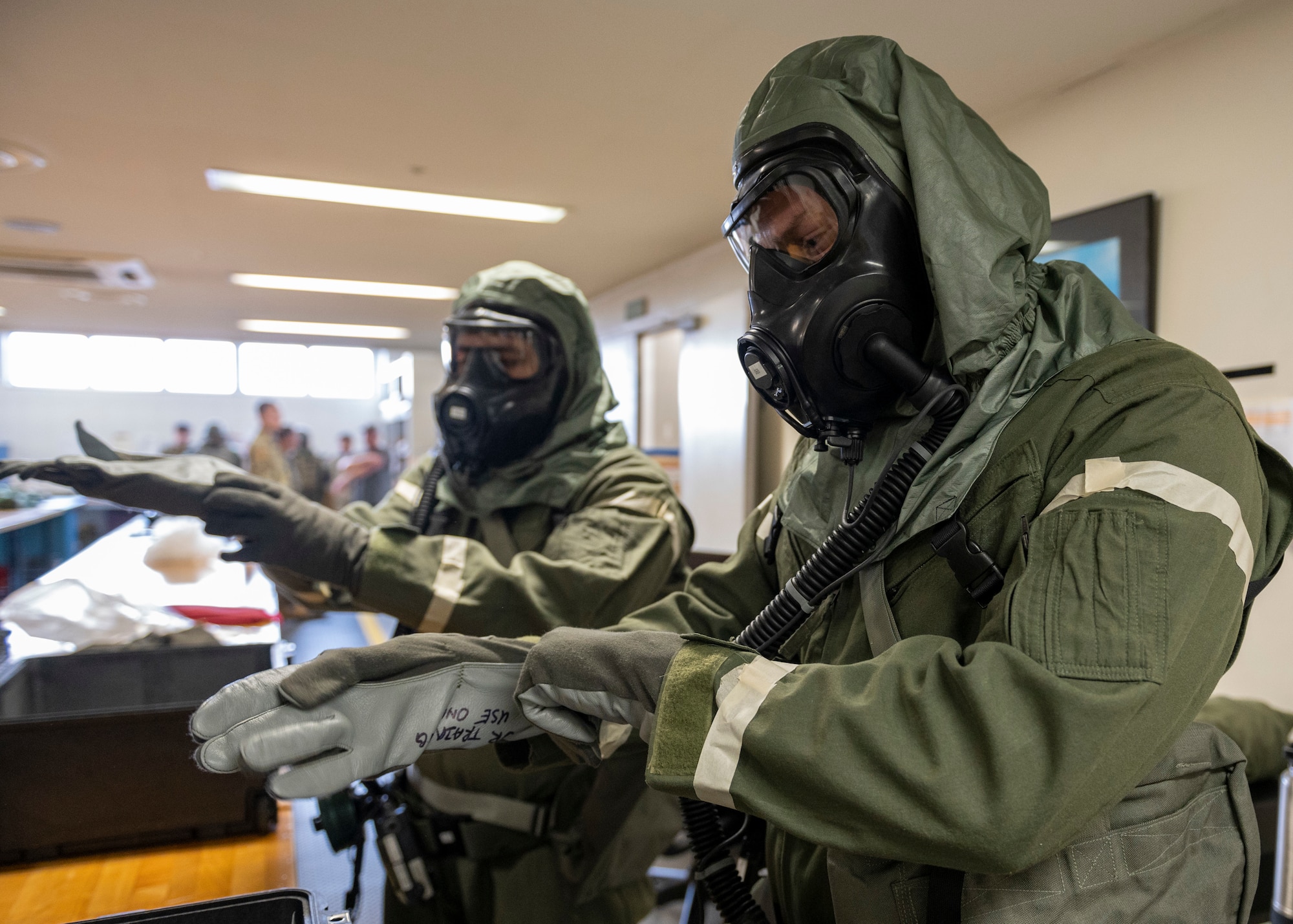 Two pilots don protective gear