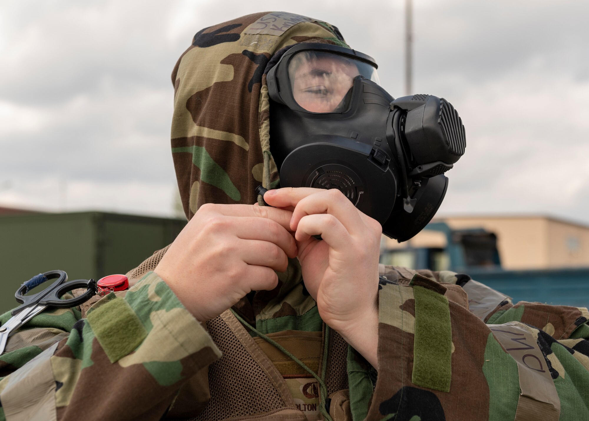 A head shot of an airman donning protective gear
