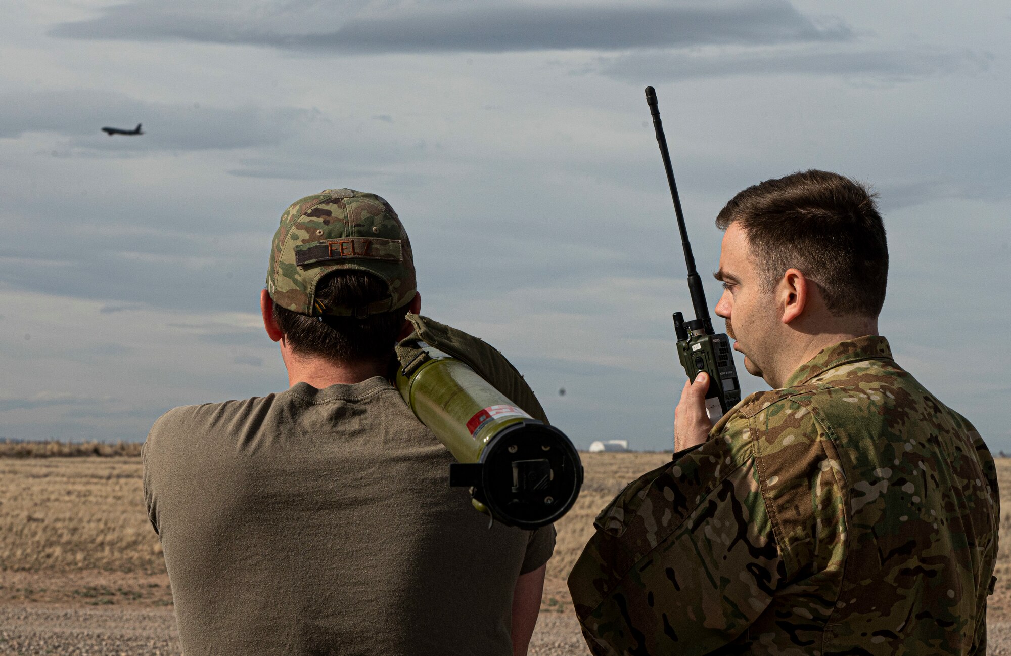 U.S. Air Force Capt. Casey Felz, 92nd Air Refueling Squadron pilot (Left), and Maj Patrick Kilbane, 509th Weapons School (WPS) instructor (Right), simulates a ground threat using a training simulated man-portable air defense [missile] system during the threats and tactics phase of the 509th WPS course at Roswell Air Center in Roswell, New Mexico, March 15, 2023.  During this training phase the 509th Weapons School students are assessed on the procedures they would use to mitigate ground threats. (U.S. Air Force photo by 2nd Lt. Ariana Wilkinson)