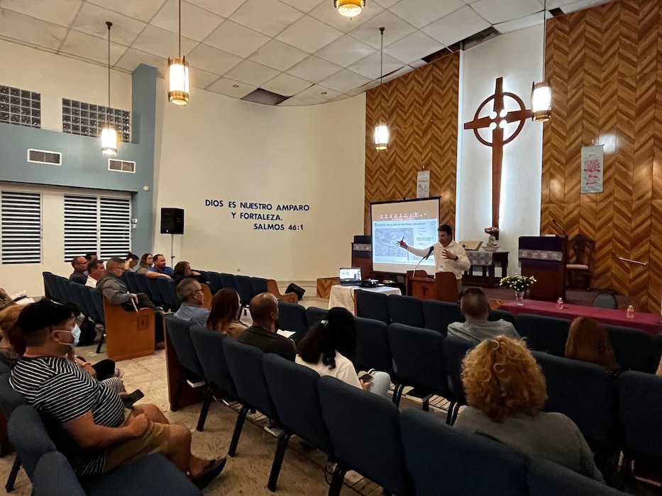 Project manager, stands at the pulpit at a public meeting.