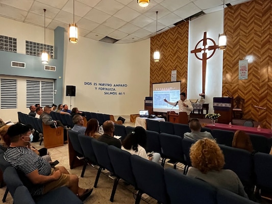 Project manager, stands at the pulpit at a public meeting.