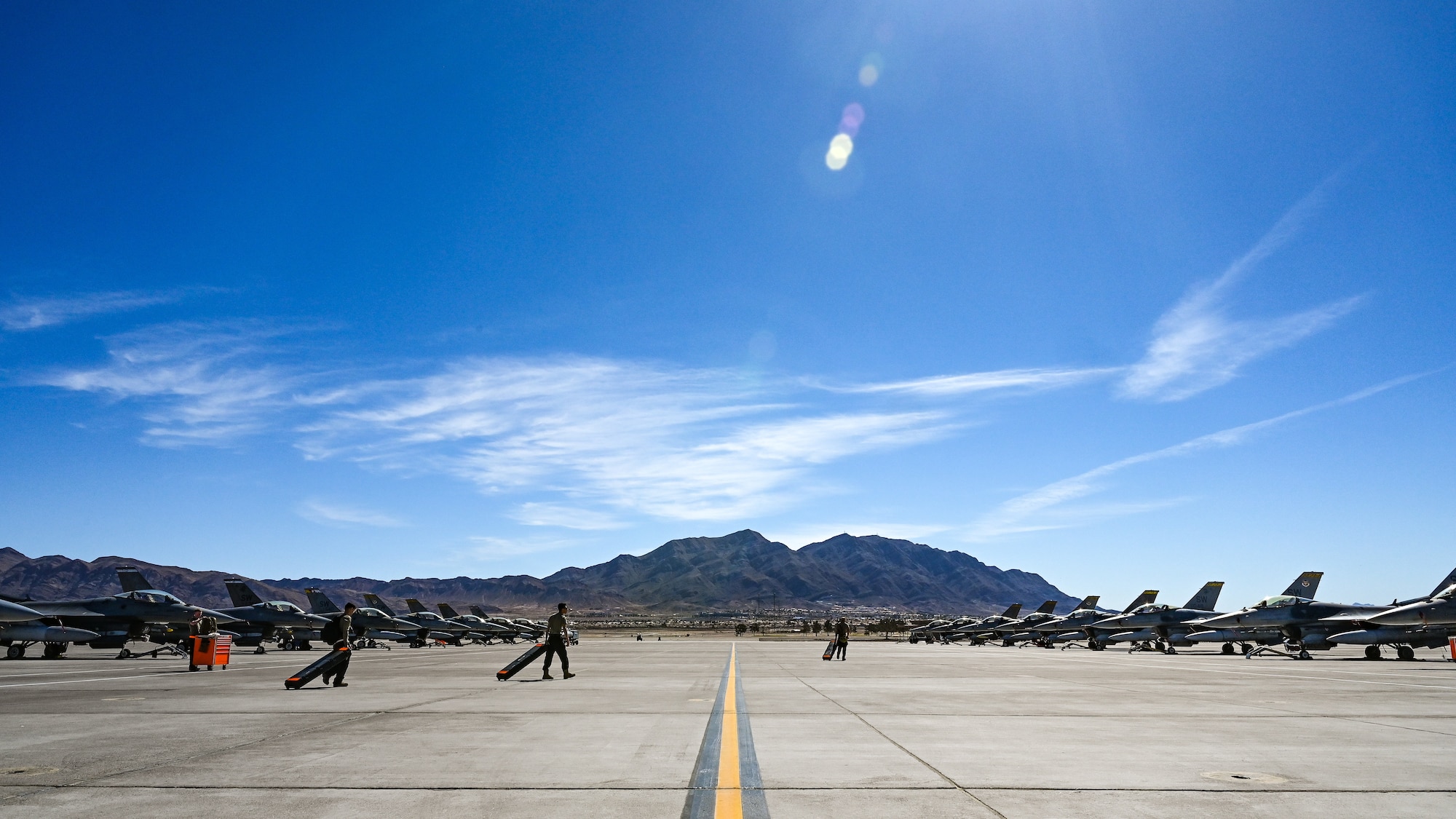 The early morning flightline becomes engaged during the first day of exercise Red Flag-Nellis (RF-N) 23-2 at Nellis Air Force Base, Nevada, March 13, 2023. RF-N 23-2 provides more complex target areas, camouflage and concealment techniques in multiple spectrums, and introduces realistic scenarios for the 20th Fighter Wing, forcing reattacks in accordance with acceptable levels of risk as it concentrates on the U.S. European Command and U.S. Central Command areas of responsibilities. (U.S. Air Force photo by Staff Sgt. Madeline Herzog)