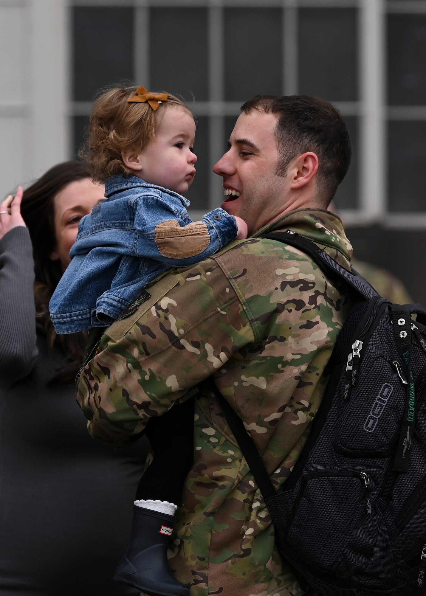 U.S. Air Force Maj. Calvin Woodard, pilot with the 8th Expeditionary Airlift Squadron, is welcomed home from a deployment by loved ones at Joint Base Lewis-McChord, Washington, April 4, 2023. This deployment was the 62d Airlift Wing’s first under the new Air Force Force Generation Model in support of U.S. Central Command, U.S. European Command and U.S. Africa Command operations. The new AFFORGEN model aims to reconstitute Air Mobility Command’s manpower, aircraft and equipment into force elements that train, deploy and recover as cohesive units throughout each phase of the cycle. (U.S. Air Force photo by Senior Airman Callie Norton)