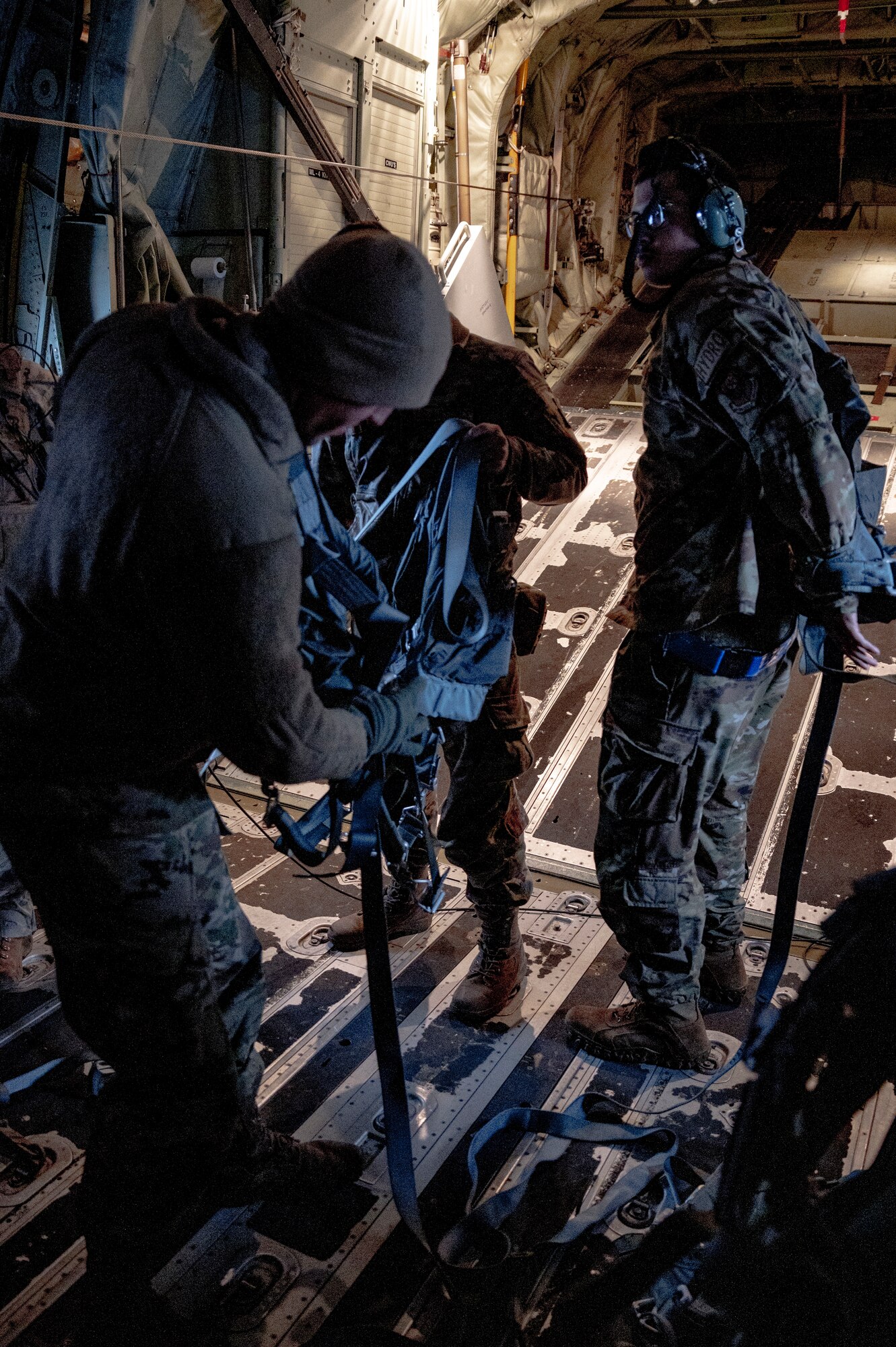 U.S. Airmen assigned to the 353rd Special Operations Wing don harnesses in the back of an MC-130J Commando II in preparation for aerial refueling during Freedom Shield 23 at Daegu Air Base, Republic of Korea, Mar. 17, 2023.
