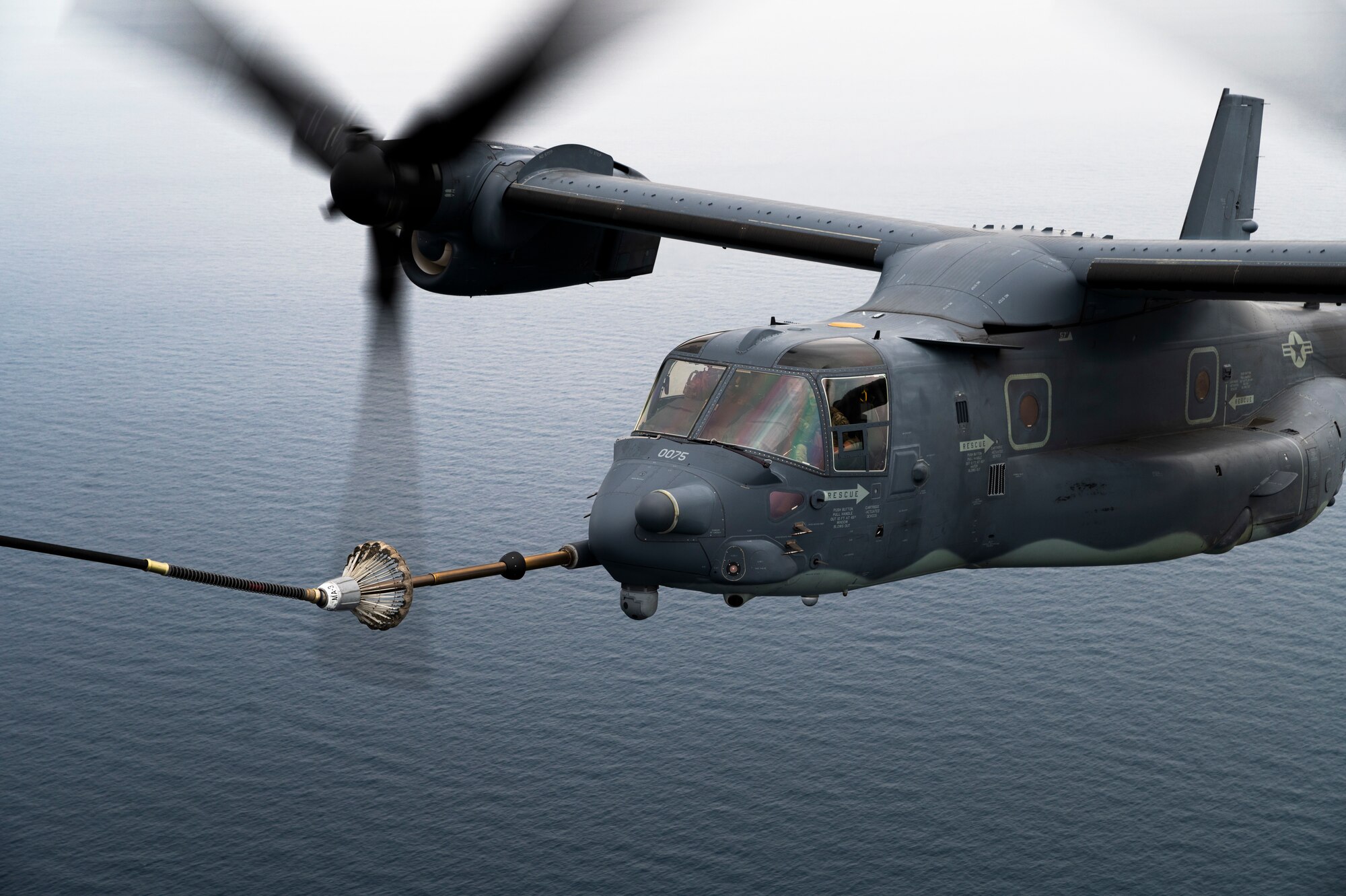 A CV-22 Osprey assigned to the 21st Special Operations Squadron (SOS) receives fuel from an MC-130J Commando II assigned to the 1st SOS during an aerial refueling mission as part of Freedom Shield 23 over the Sea of Japan, Mar. 17th, 2023.