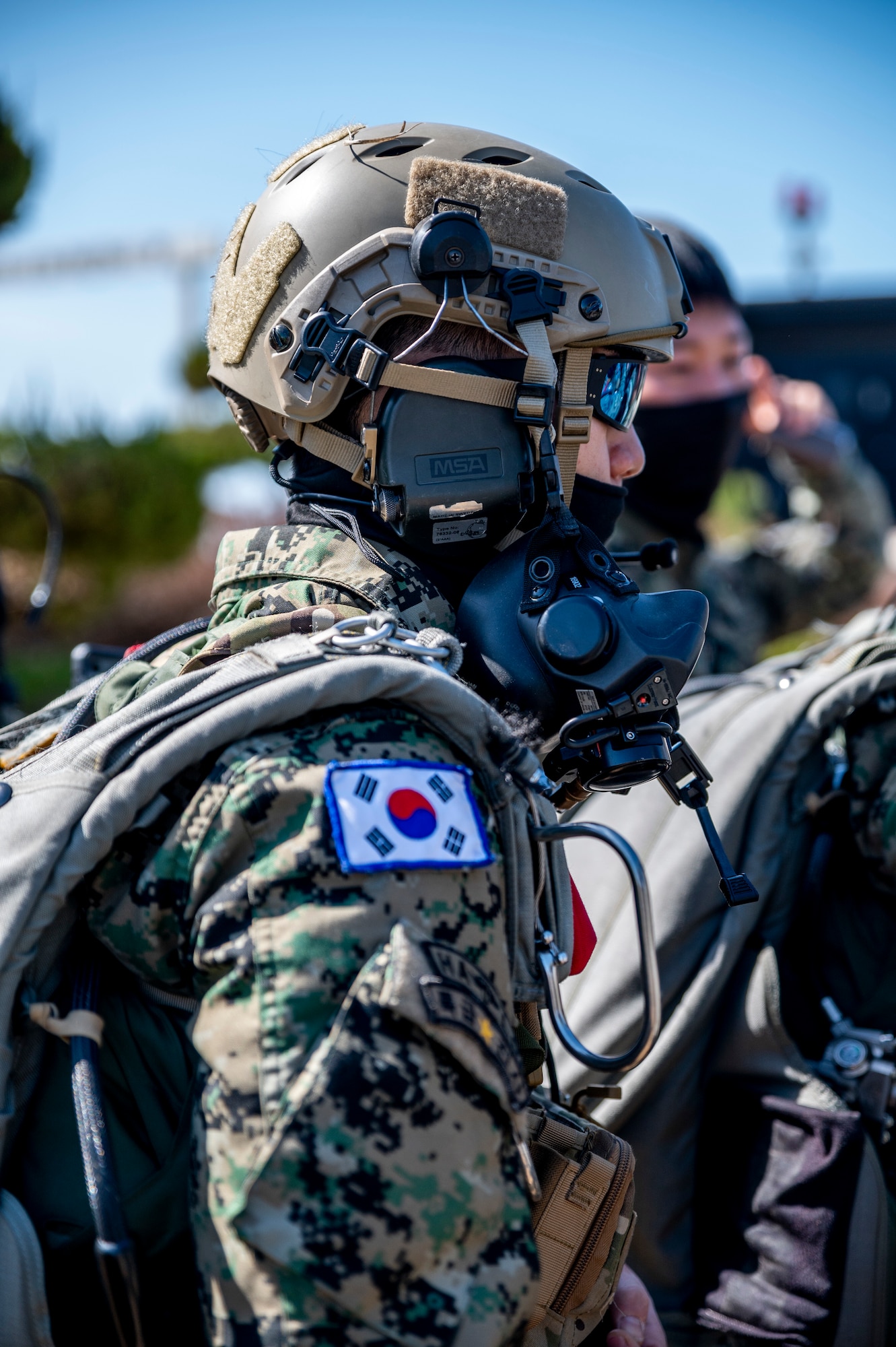 Republic of Korea Soldiers listen to a pre-brief before boarding an MC-130J Commando II to conduct High Altitude Low Opening (HALO) jump training in support of Freedom Shield 23 at Kunsan Air Base, ROK, Mar. 15, 2023.
