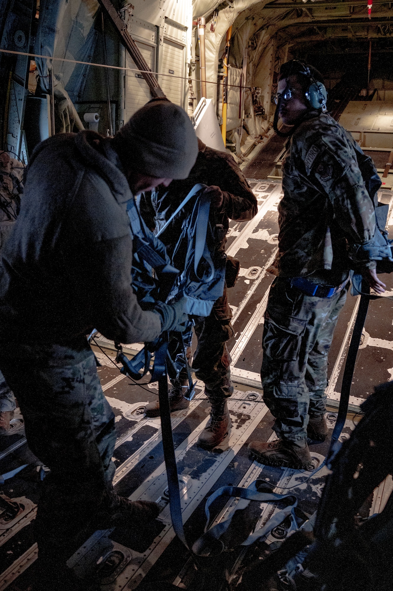 U.S. Airmen assigned to the 353rd Special Operations Wing don harnesses in the back of an MC-130J Commando II in preparation for aerial refueling during Freedom Shield 23 at Daegu Air Base, Republic of Korea, Mar. 17, 2023.