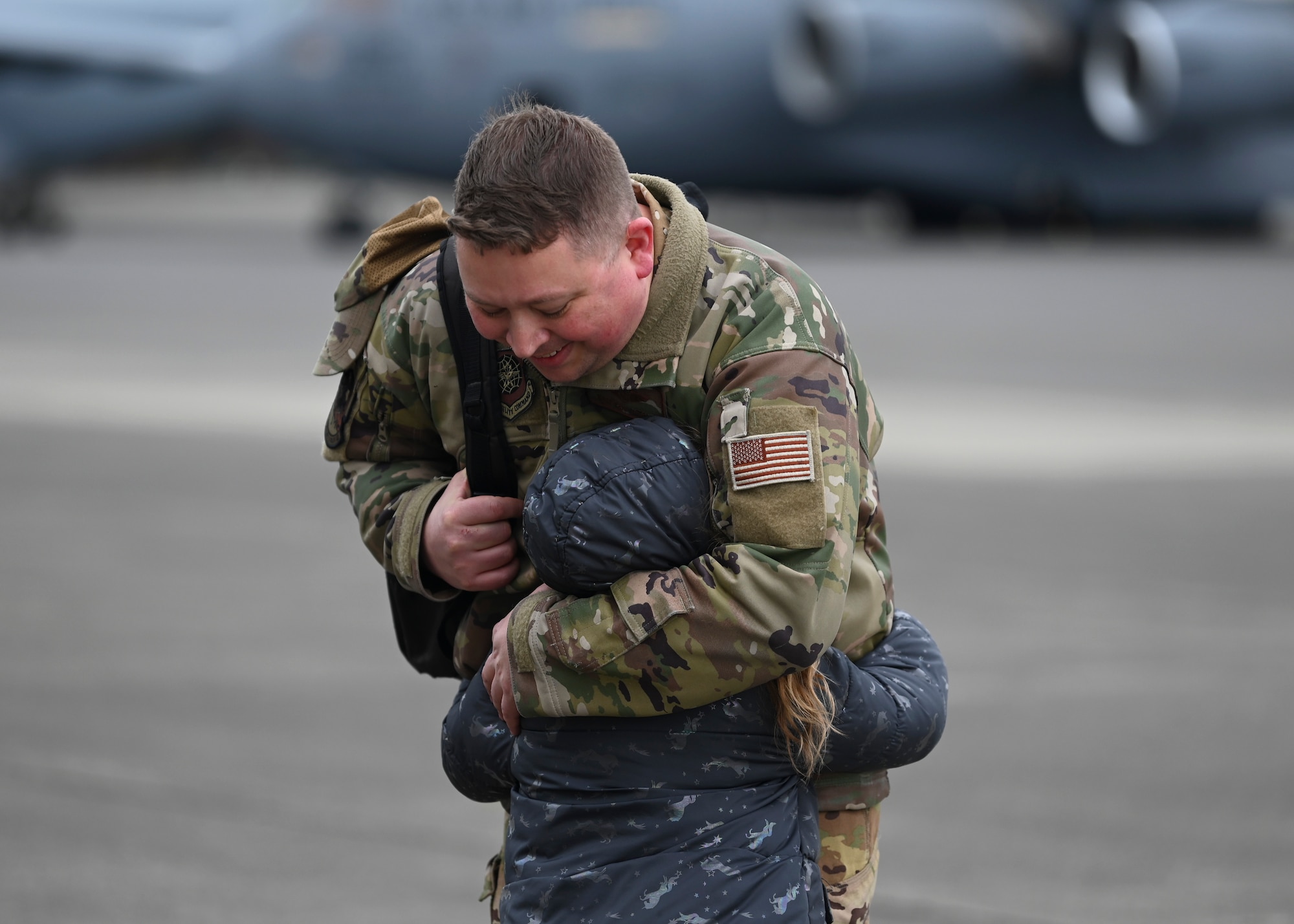 U.S. Air Force Master Sgt. Eric Pietras, loadmaster with the 8th Expeditionary Airlift Squadron, is welcomed home from a deployment by a loved one at Joint Base Lewis-McChord, Washington, April 4, 2023. This deployment was the 62d Airlift Wing’s first under the new Air Force Force Generation Model in support of U.S. Central Command, U.S. European Command and U.S. Africa Command operations. The new AFFORGEN model aims to reconstitute Air Mobility Command’s manpower, aircraft and equipment into force elements that train, deploy and recover as cohesive units throughout each phase of the cycle. (U.S. Air Force photo by Senior Airman Callie Norton)