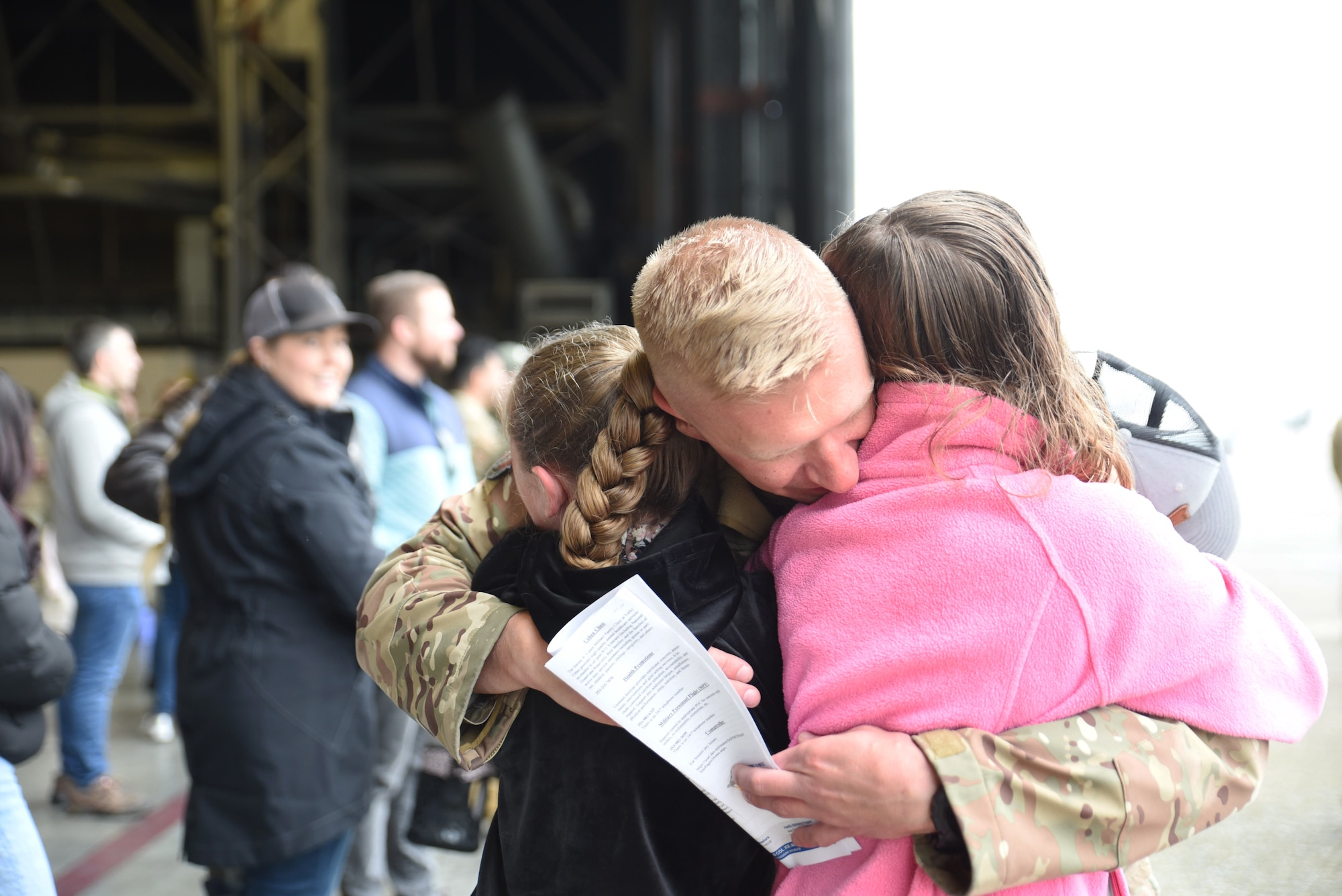 U.S. Air Force Master Sgt. Todd Sherman, production superintendent with the 8th Expeditionary Airlift Squadron, hugs his daughters after returning from deployment at Joint Base Lewis-McChord, Washington, April 4, 2023. The deployment was the 62d Airlift Wing’s first under the new Air Force Force Generation Model in support of U.S. Central Command, U.S. European Command and U.S. Africa Command operations. (U.S. Air Force Photo by Airman 1st Class Kylee Tyus)