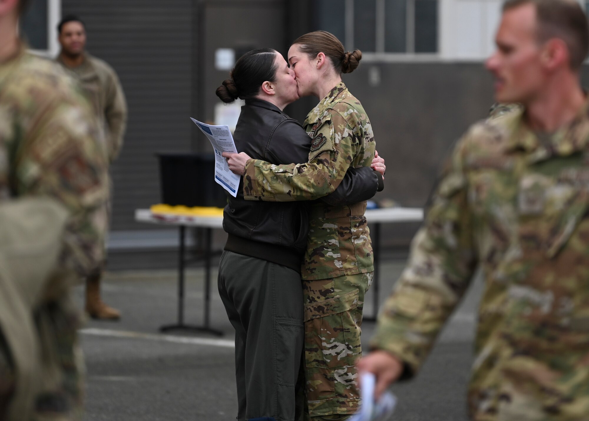 A U.S. Airman with the 62d Airlift Wing is welcomed home from a deployment by a loved one at Joint Base Lewis-McChord, Washington, April 4, 2023. This deployment was the 62d Airlift Wing’s first under the new Air Force Force Generation Model in support of U.S. Central Command, U.S. European Command and U.S. Africa Command operations. The new AFFORGEN model aims to reconstitute Air Mobility Command’s manpower, aircraft and equipment into force elements that train, deploy and recover as cohesive units throughout each phase of the cycle. (U.S. Air Force photo by Senior Airman Callie Norton)