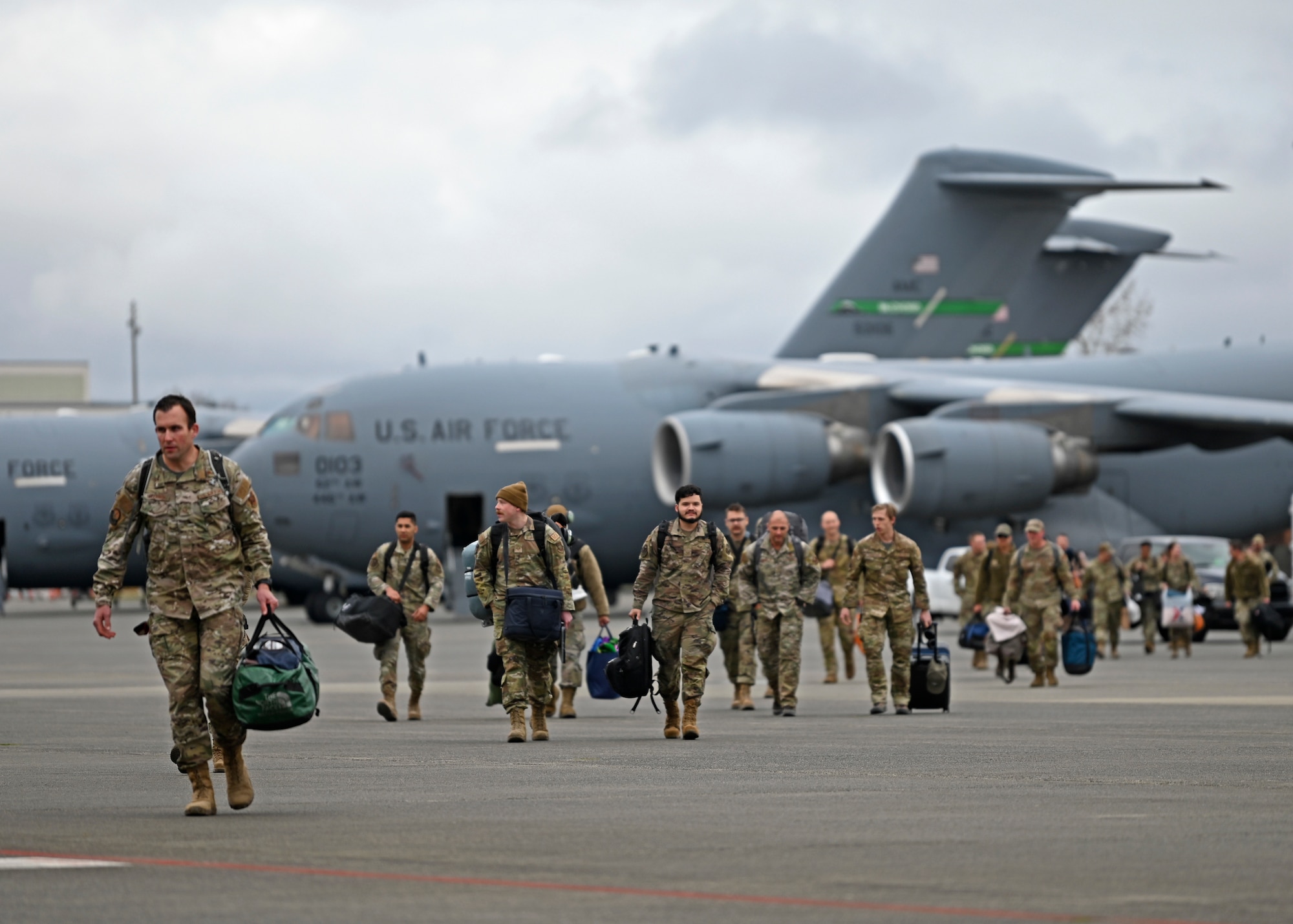U.S. Airmen with the 62d Airlift Wing return from a deployment at Joint Base Lewis-McChord, Washington, April 4, 2023. This deployment was the 62d Airlift Wing’s first under the new Air Force Force Generation Model in support of U.S. Central Command, U.S. European Command and U.S. Africa Command operations. The new AFFORGEN model aims to reconstitute Air Mobility Command’s manpower, aircraft and equipment into force elements that train, deploy and recover as cohesive units throughout each phase of the cycle. (U.S. Air Force photo by Senior Airman Callie Norton)