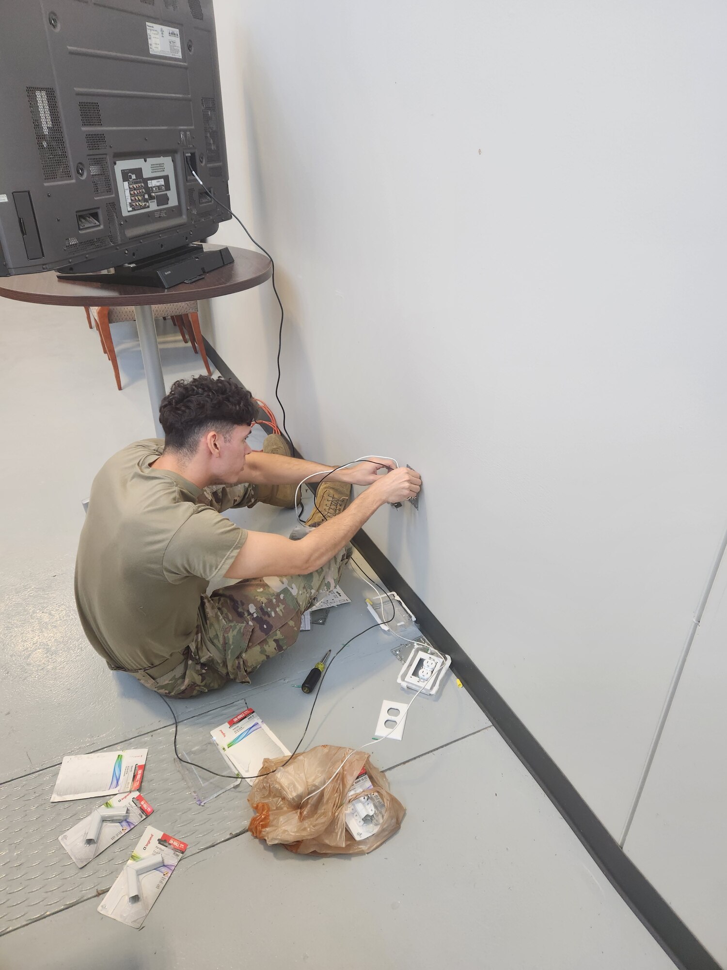 a man fixes an outlet box