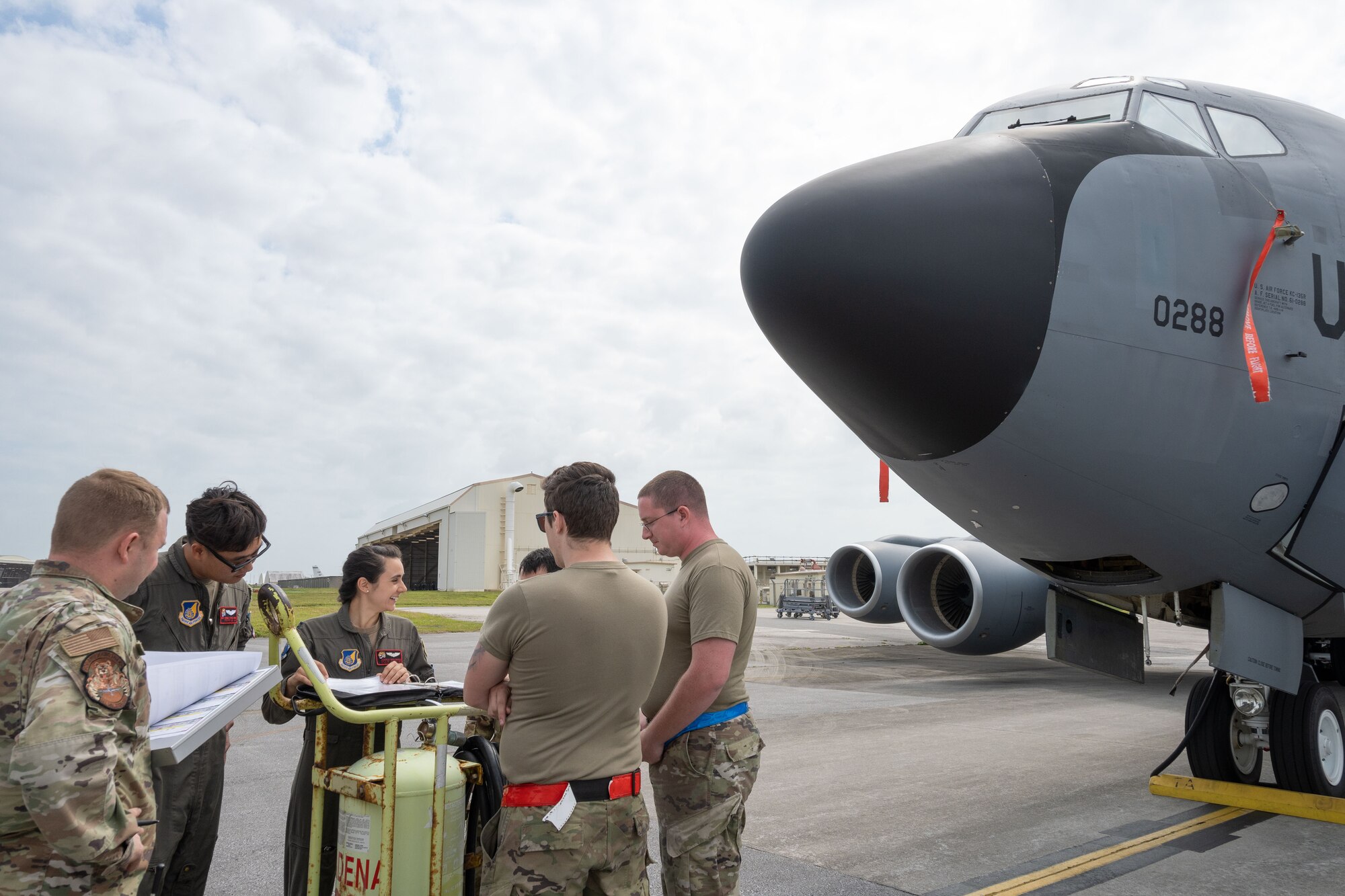 Airmen stand next to a KC-135 Stratotanker