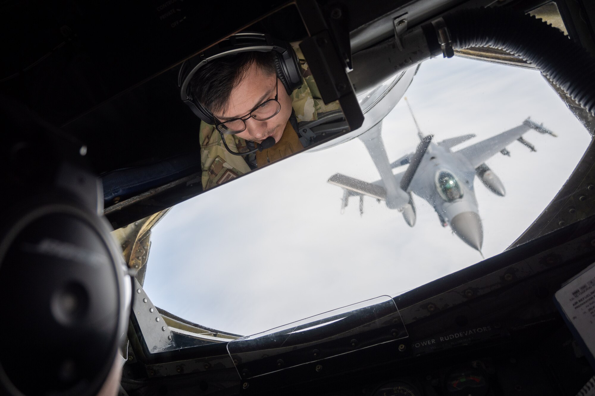 Airman looks at an approaching jet