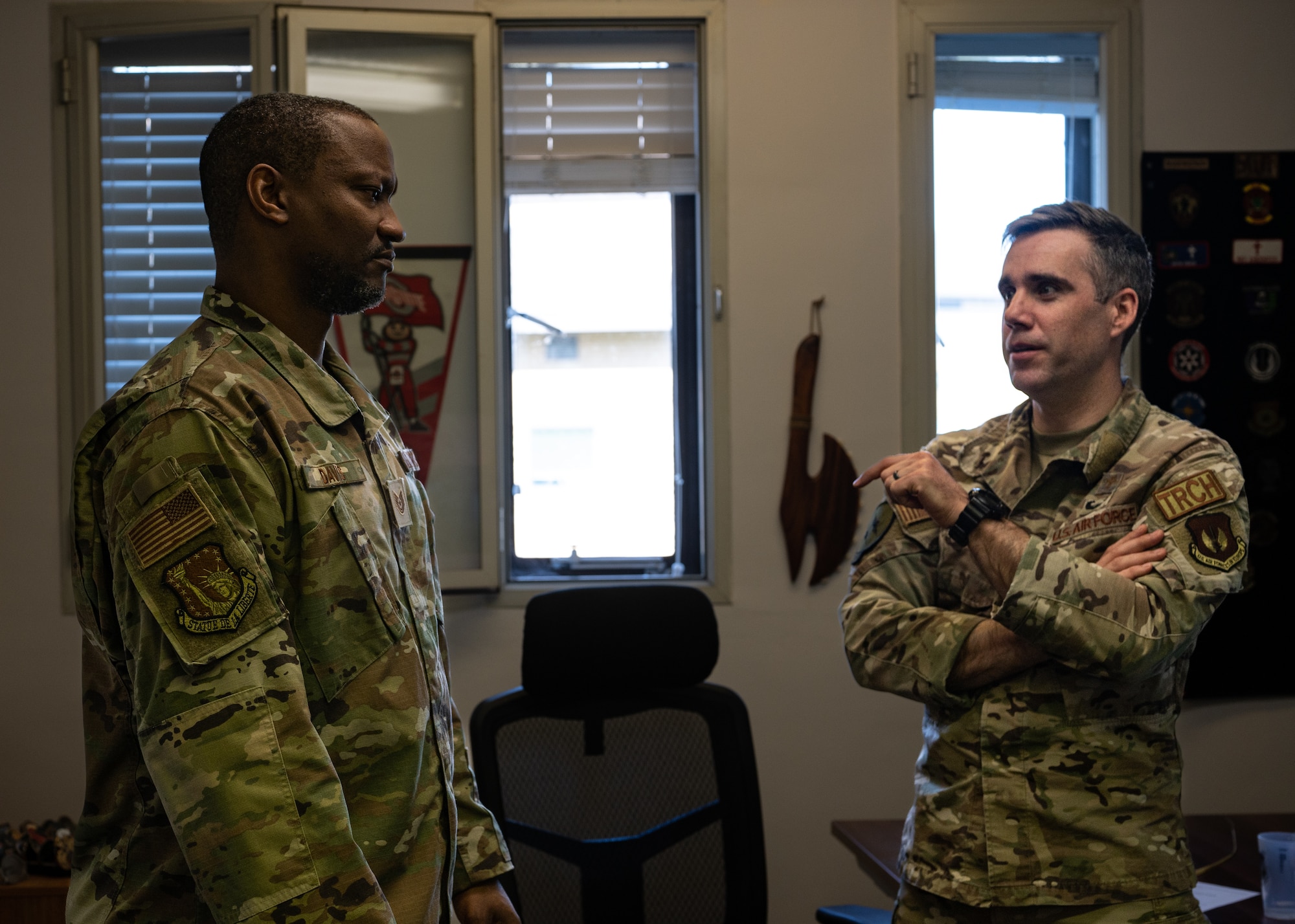 U.S. Air Force Tech. Sgt. Dundre Davis, Liberty Wing Chapel noncommissioned officer in charge of programs and administration, and 48th Fighter Wing Chaplain (Maj.) Justin Szeker review duties of the work week at Royal Air Force Lakenheath, England, April 3, 2023.