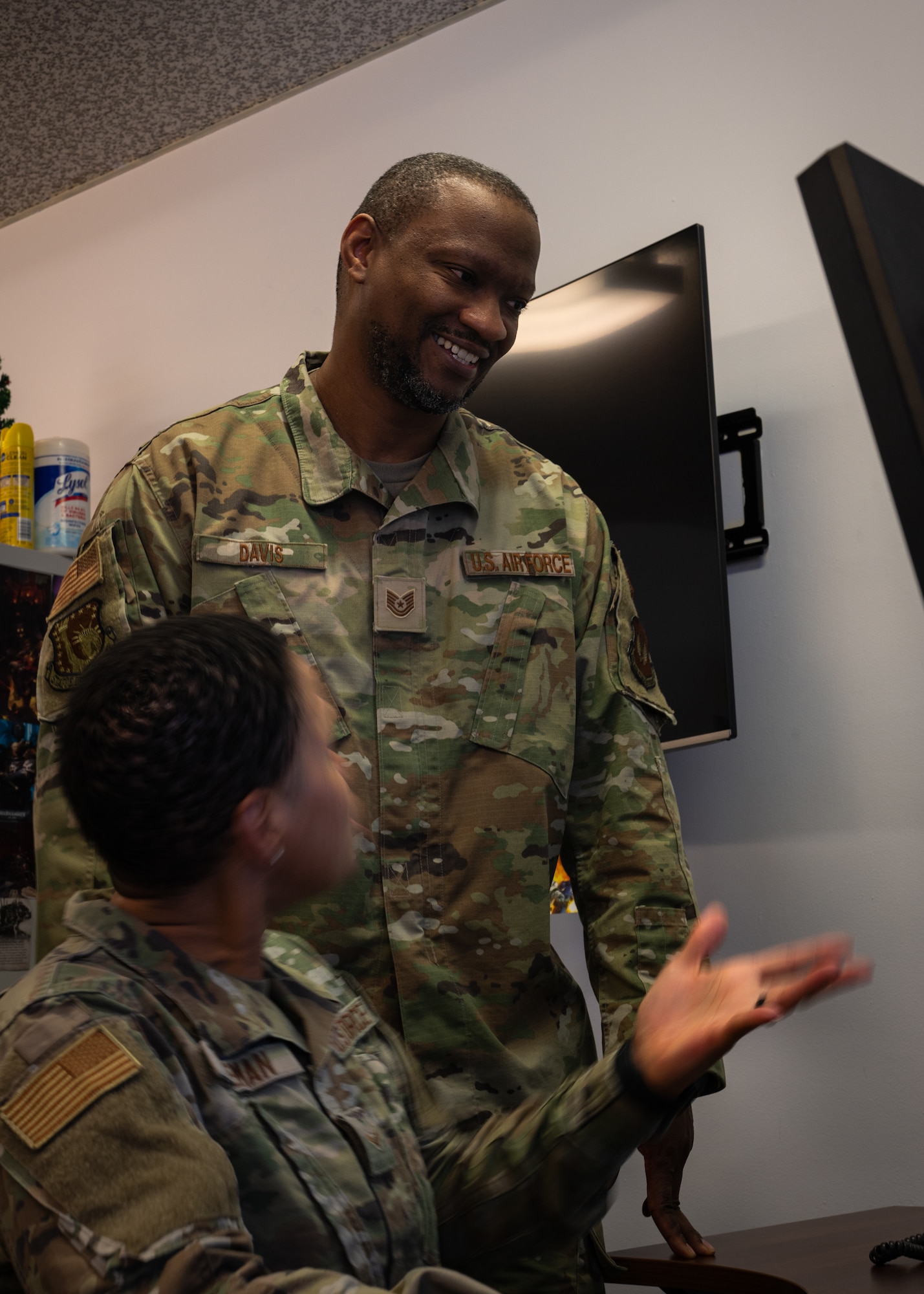 U.S. Air Force Tech. Sgt. Dundre Davis, Liberty Wing Chapel noncommissioned officer in charge of programs and administration, helps Airman 1st Class Shayla Coleman, Religious Affairs Airman, with scheduling on a computer at Royal Air Force Lakenheath, England, April 3, 2023.