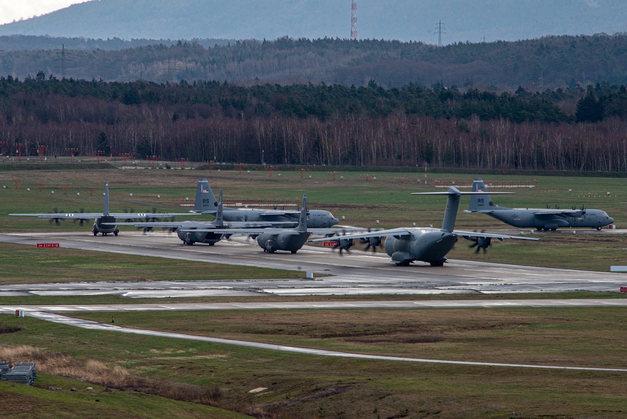 Five U.S. Air Force C-130J Super Hercules aircraft and one German air force A-400M Atlas aircraft prepare to take-off March 30, 2023 at Ramstein Air Base, Germany.