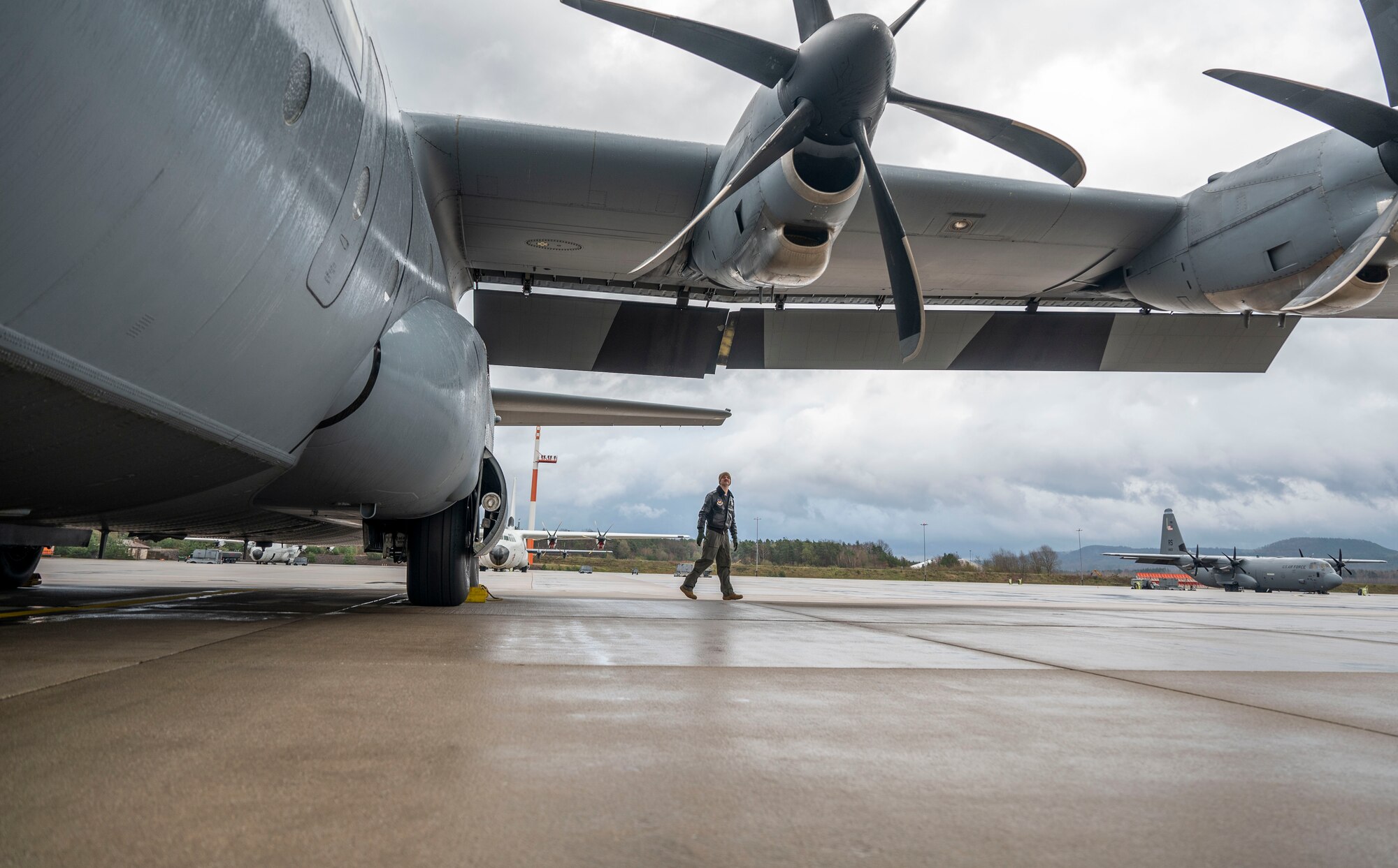 U.S. Air Force Capt. Gregg Burrow, 37th Airlift Squadron C-130J Super Hercules pilot, performs a pre-flight inspection on a C-130J aircraft at Ramstein Air Base, Germany, March 31, 2023.