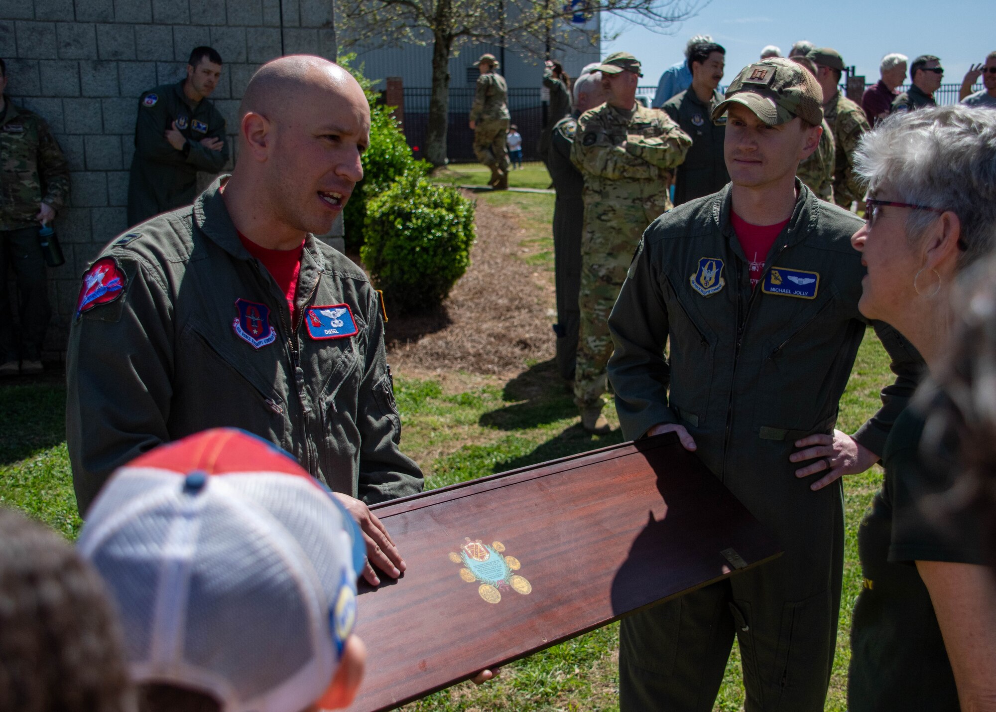 people in military uniforms burn a piano for a ceremony