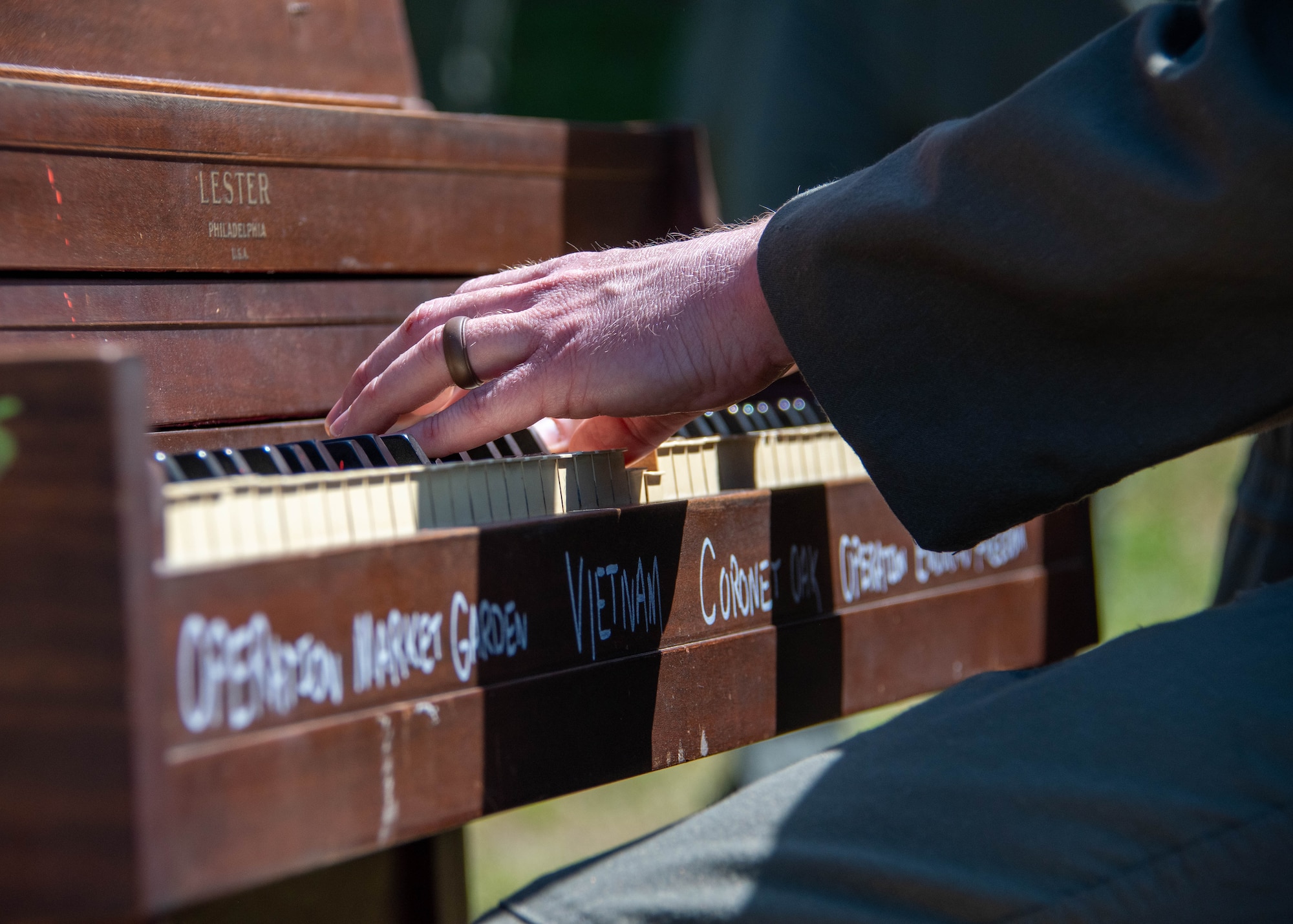 a person plays a burning piano during a ceremony
