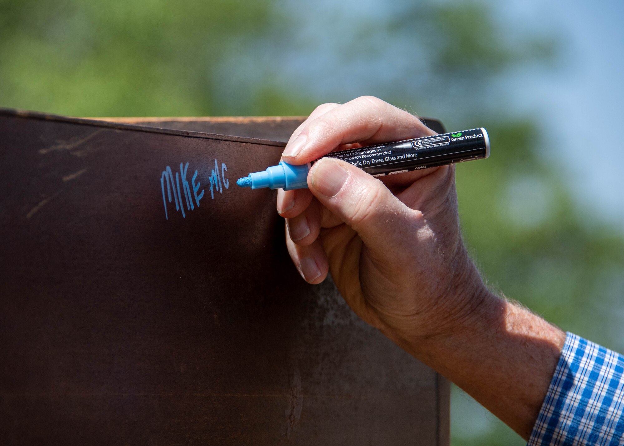 a person signs a piano during a ceremony