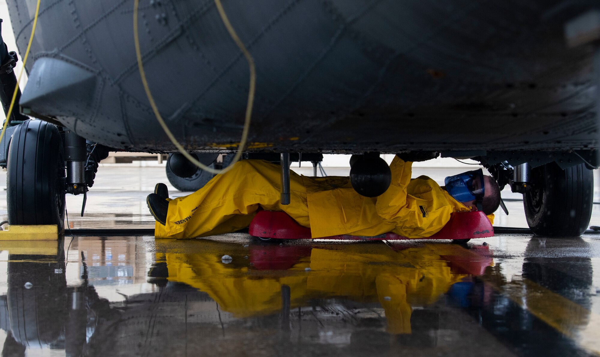 U.S. Air Force Capt. Justin Berte, 56th Rescue Generation Squadron director of operations, washes the belly of an HH-60G Pave Hawk helicopter as part of an immersion tour