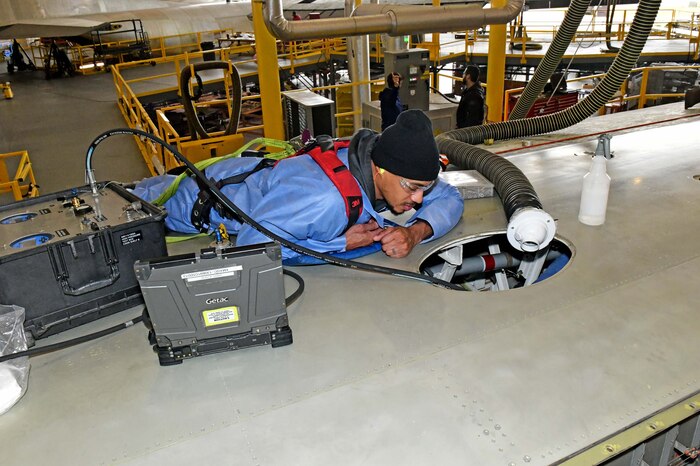 Man working on aircraft wing