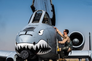 U.S. Air Force Captain Connor Jones, 75th Expeditionary Fighter Squadron A-10 Thunderbolt II pilot, climbs into his aircraft before the first sortie at Al Dhafra Air Base, United Arab Emirates, April 6, 2023. Since its creation in 1975, the A-10 has provided air support to ground troops, destroying adversary forces and infrastructure as the first aircraft designed specifically for close air support. (U.S. Air Force photo by Staff Sgt Sabatino DiMascio)