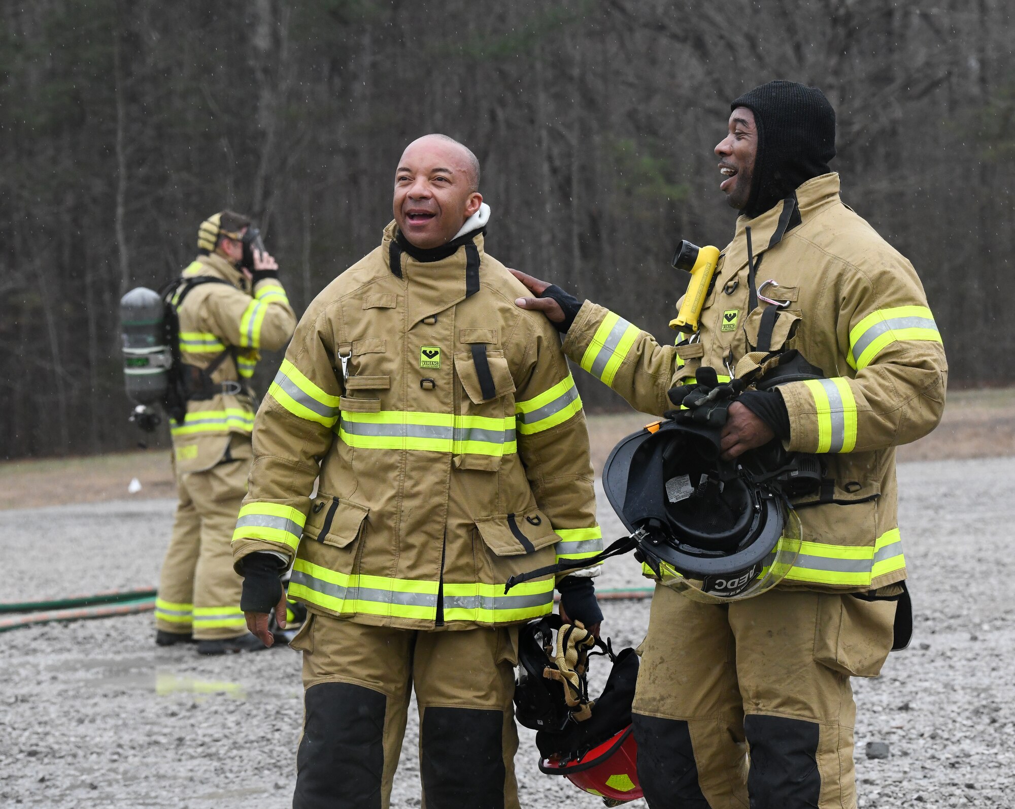 Men in firefighting gear laughing