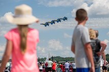 Two children watching planes fly