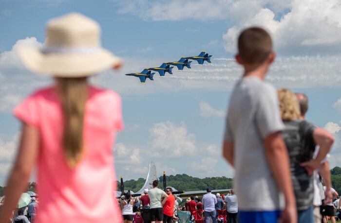 Two children watching planes fly