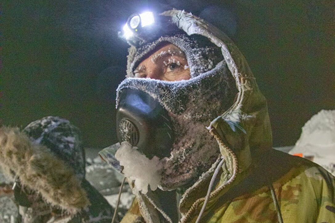 Close-up of airman wearing a headlamp in freezing temperatures.