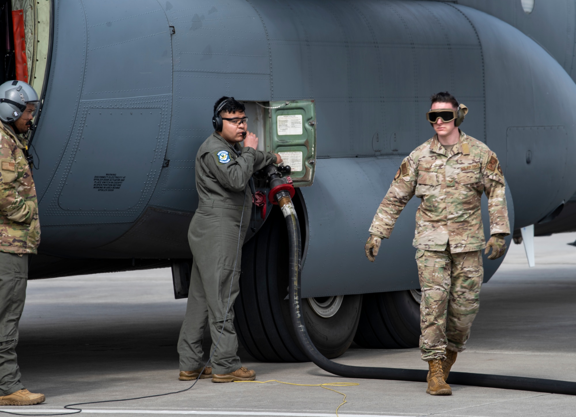 Airmen use fuel hose on aircraft