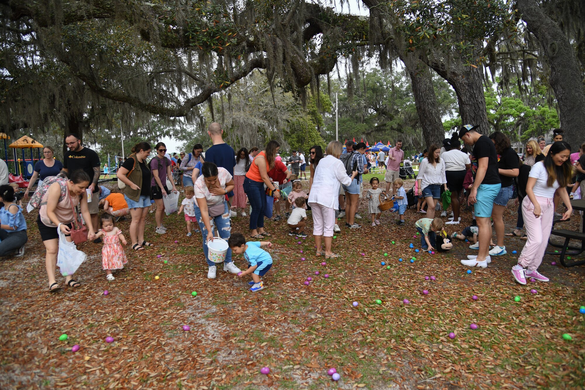 Children of Keesler personnel pick up Easter eggs during Easter in the Park at Keesler Air Force Base, Mississippi, April 1, 2023.