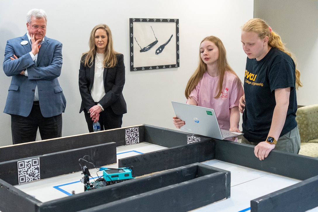 IMAGE: – Dean of the University of Mary Washington’s College of Business Ken Machande and Naval Surface Warfare Center Chief Technology Officer Jennifer Clift observe as the Northern Neck Regional Technical Center robotics team tests their robot on a practice course in preparation for the competition phase of the second annual High School Innovation Challenge @ Dahlgren.