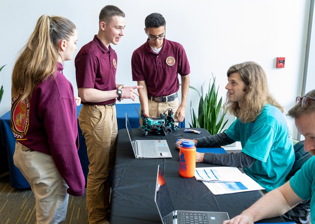IMAGE: Naval Surface Warfare Center Dahlgren Division computer scientist Lucas Durham checks over the coding produced by the Mountain View High School robotics team after they competed in the second annual High School Innovation Challenge @ Dahlgren.