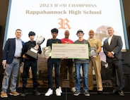 IMAGE: Naval Surface Warfare Center Dahlgren Division’s Technical Director Dale Sisson Jr., SES, Commanding Officer Capt. Philip Mlynarski and University of Mary Washington’s Dr. John Burrow (left) pose with this year’s High School Innovation Challenge @ Dahlgren championship team from Rappahannock High School. Ricardo Alvarez (second from left), Michael Martinez and Cain Edwards, with assistance from physics teacher Preston Ailor, won the competition by remotely controlling their robot through the course.