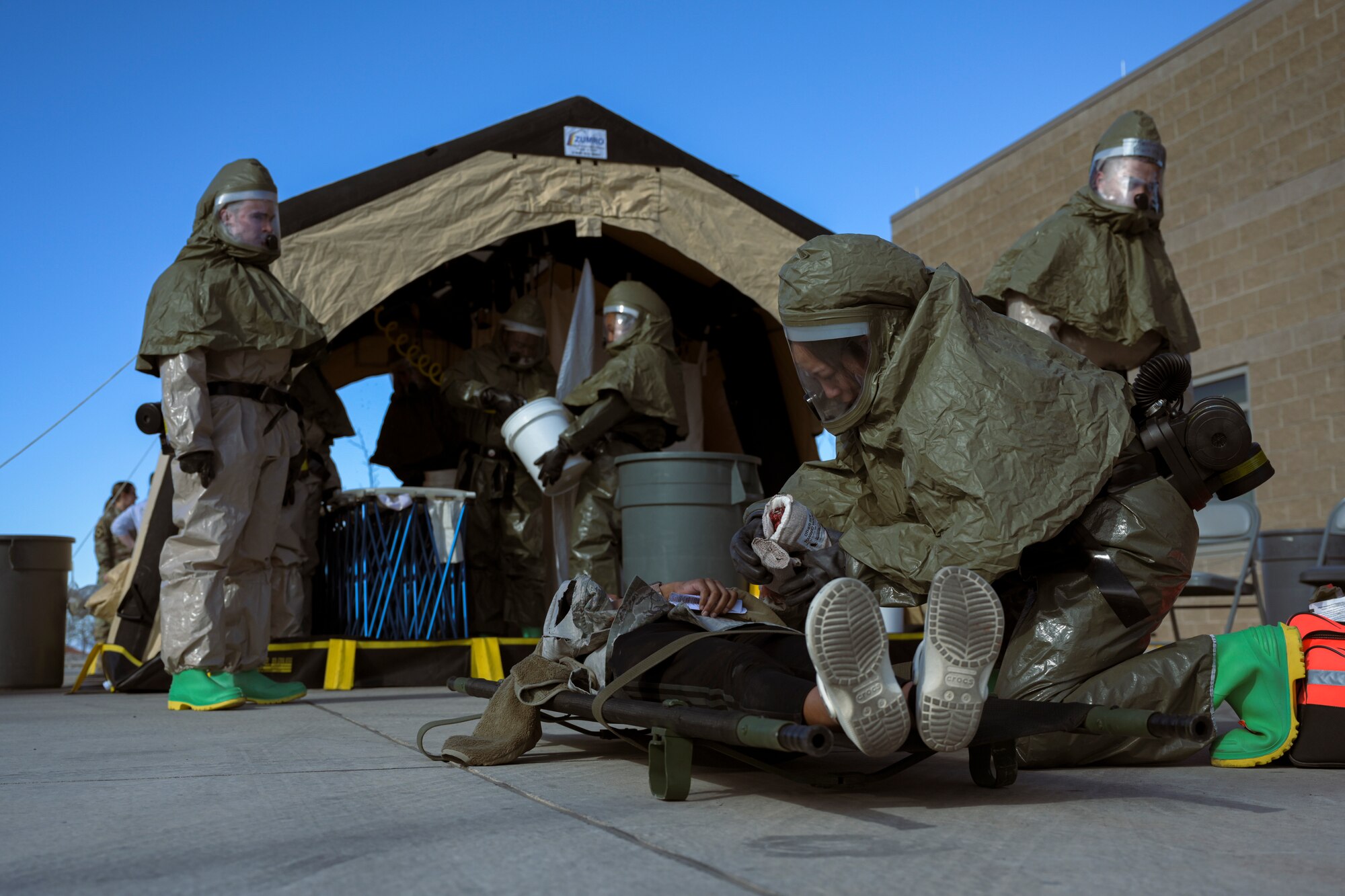 Members from the 49th Medical Group prepare a patient to be transported during a Ready Eagle exercise at Holloman Air Force Base, New Mexico, March 30, 2023. The initial response teams were responsible for on-the-scene care and patient transport. (U.S. Air Force by Senior Airman Antonio Salfran)