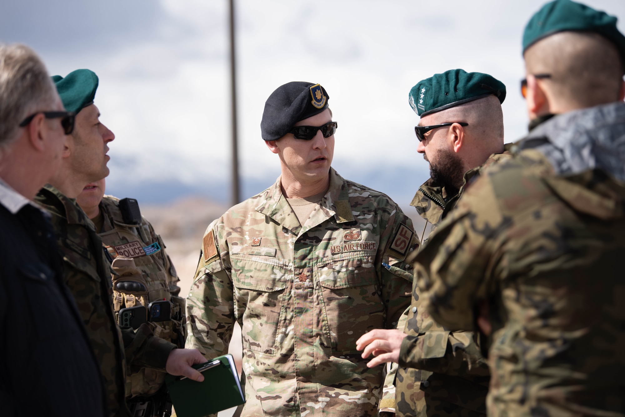 U.S Air Force Airmen and Polish delegation gather around and brief on RPA mission equipment.
