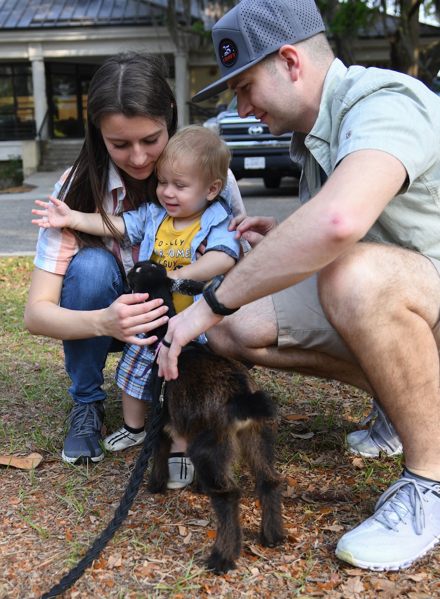U.S. Air Force 2nd Lt. Nathan Rupp, 333rd Training Squadron student, his wife, Alia, and son, Rowan, visit with a baby goat during Easter in the Park at Keesler Air Force Base, Mississippi, April 1, 2023.