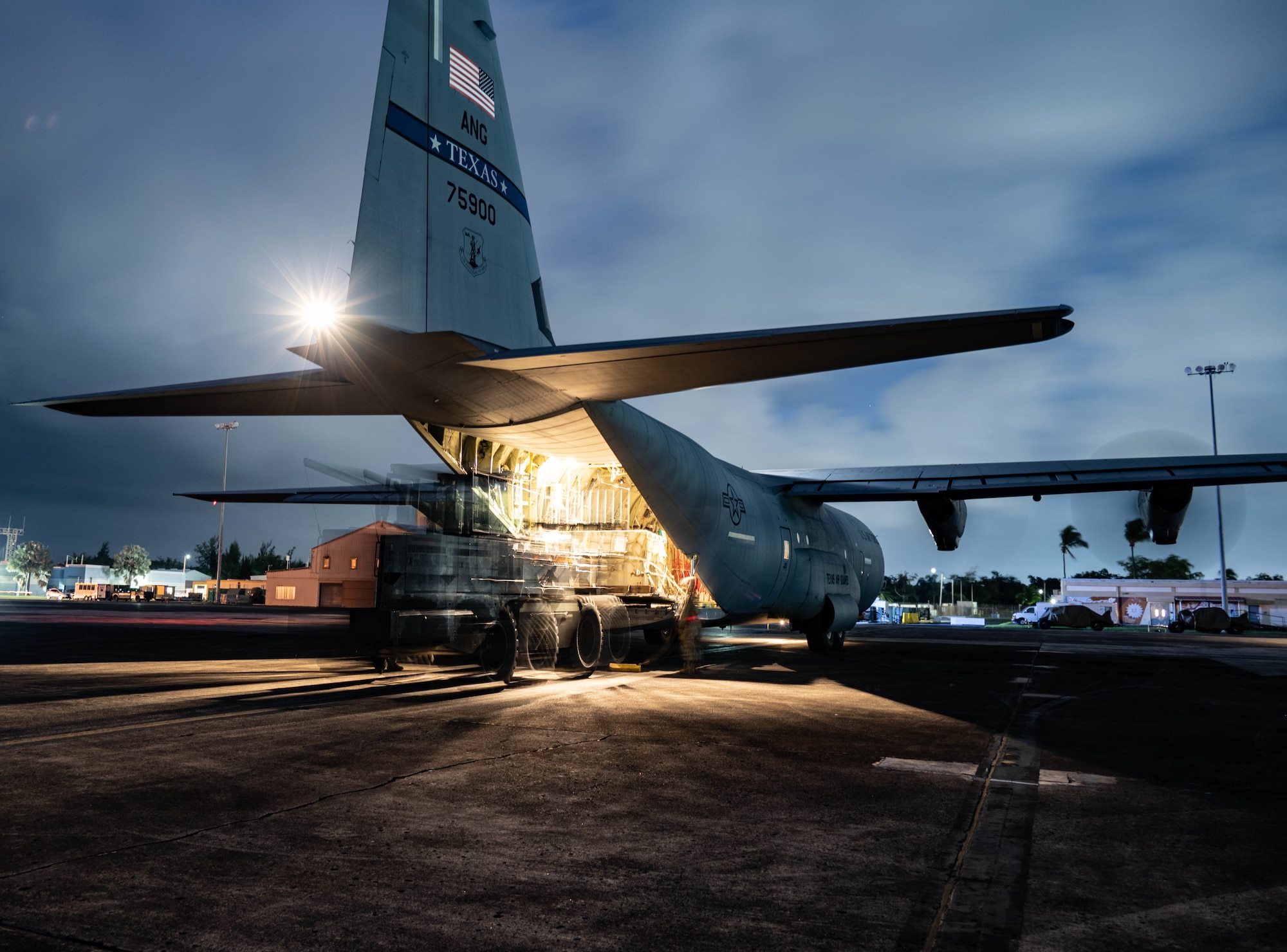 Pallets are loaded onto the backend of a C-130J.