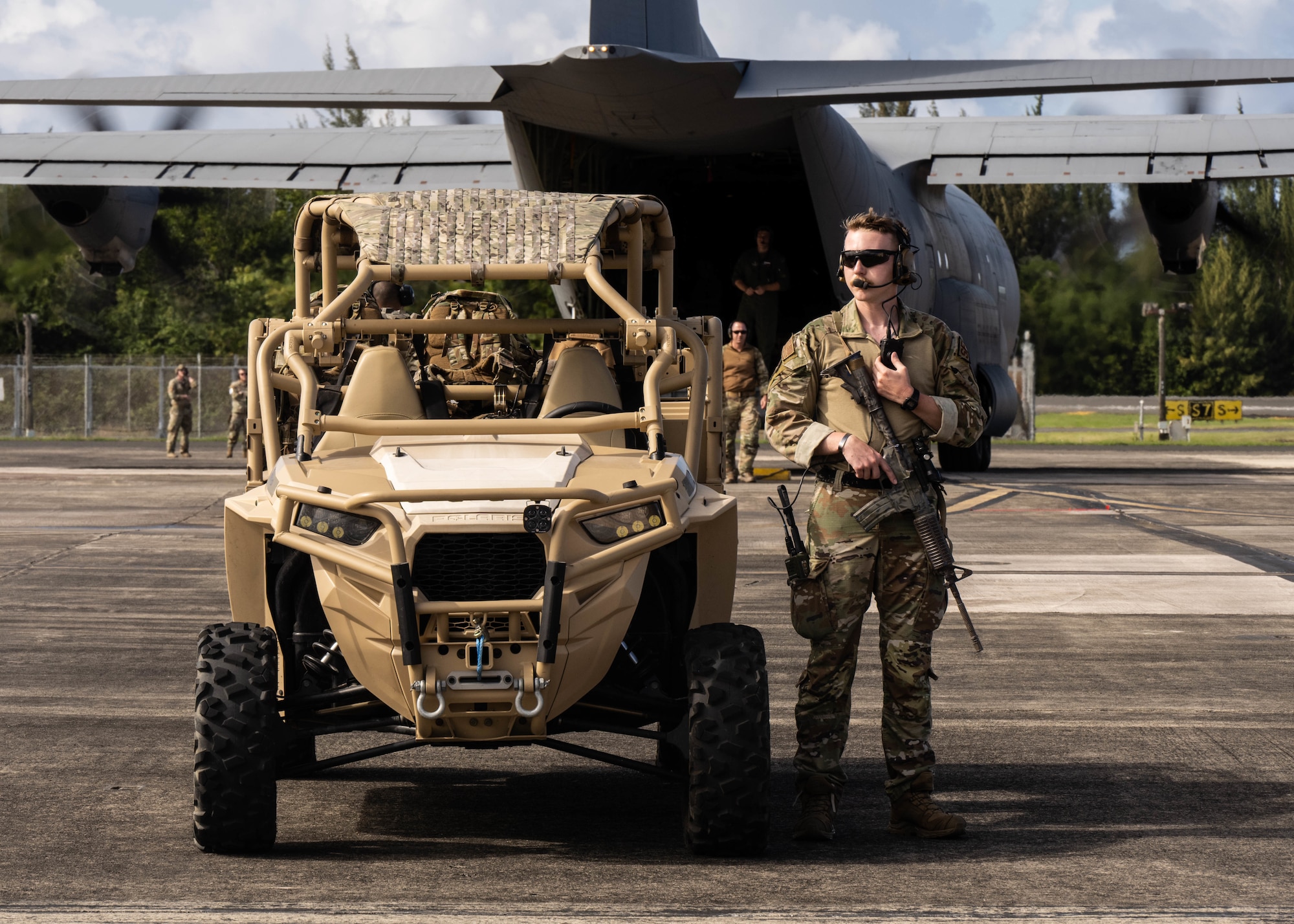 Airman walks next to vehicle while performing safety checks on the flight line.