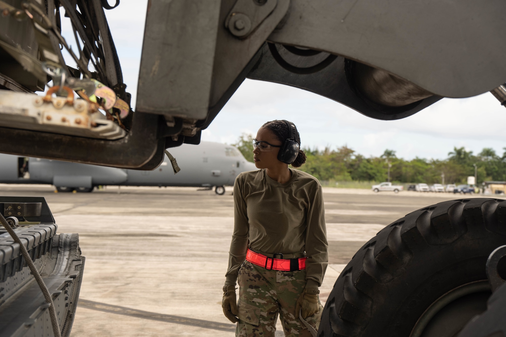 Airman observes pallet loading onto a C-130J.